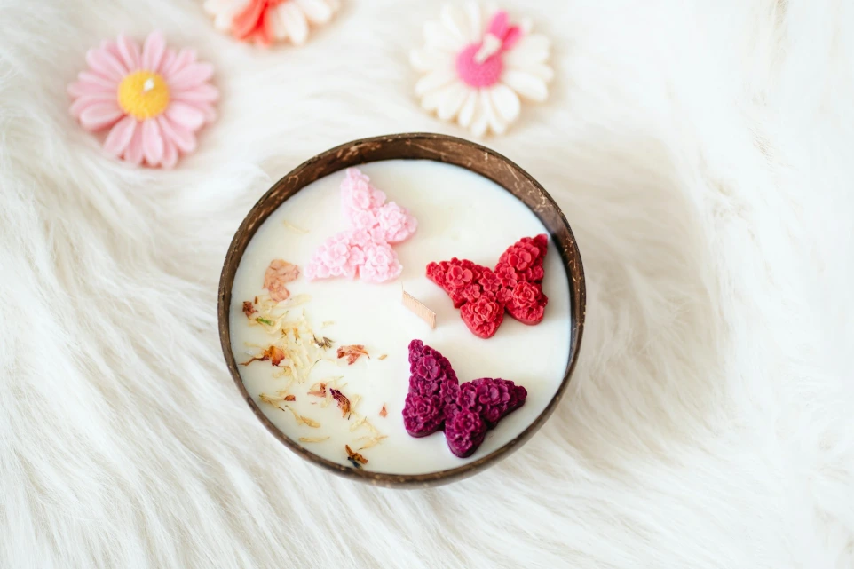 A bowl filled with milk and crocheted butterflies